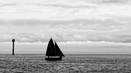 Sailboat on sea against sky