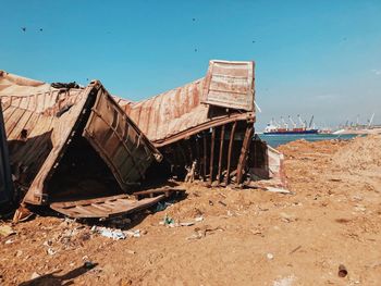 Abandoned built structure on beach against clear sky