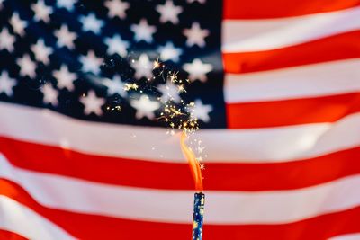 Full frame shot of american flag with sparkler