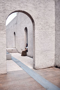 Woman sitting on wall