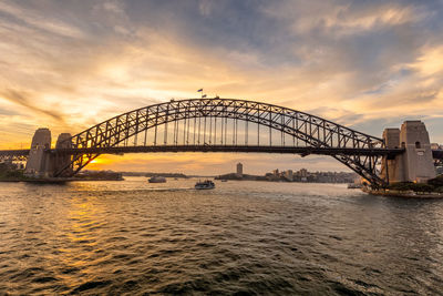 View of bridge over river during sunset