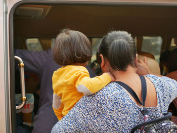 Rear view of people sitting in bus