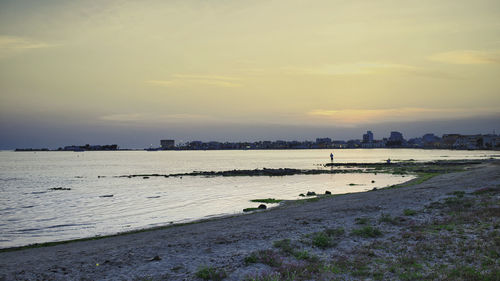 Scenic view of beach against sky during sunset