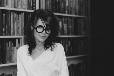 Portrait of young woman with eye glasses in library