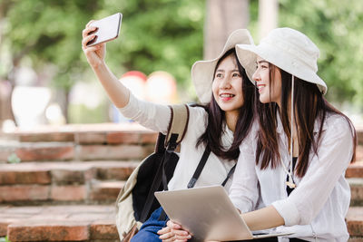 Young woman using mobile phone outdoors