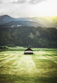 High angle view of house on landscape with mountains in background