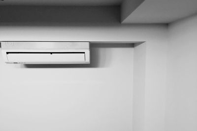 Low angle view of air conditioner on wall at home