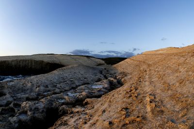 Scenic view of arid landscape against sky