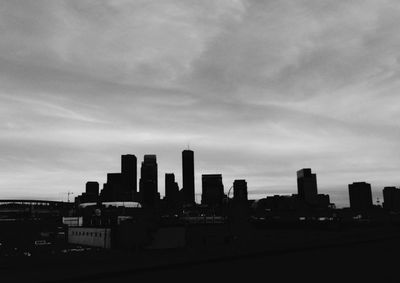 Skyscrapers against cloudy sky