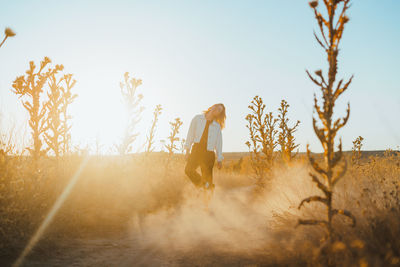 Woman on field against clear sky