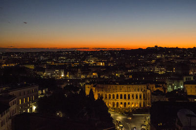 High angle view of illuminated buildings against sky at sunset