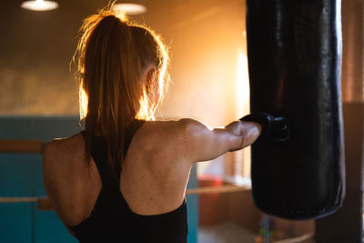 Rear view of woman exercising in gym