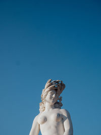 Low angle view of statue against clear blue sky