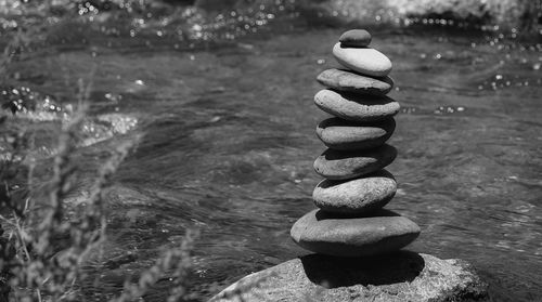 Stack of stones on rock in river