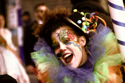 Portrait of happy mid adult woman in face paint standing outdoors