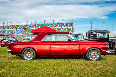 Vintage car on grass against sky