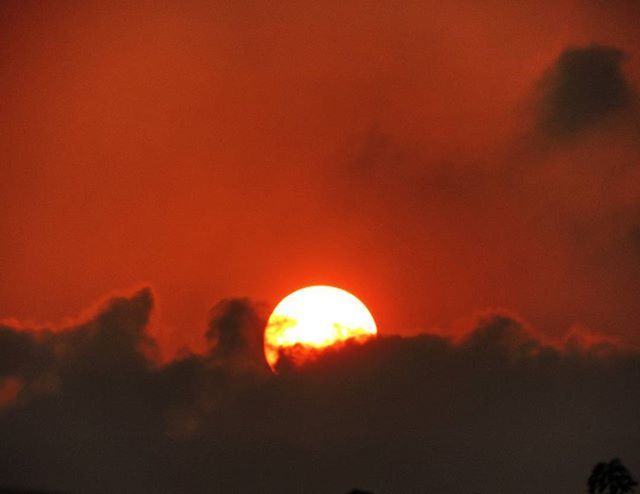 SUN SHINING THROUGH CLOUDS