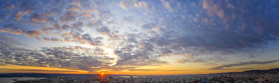 Panoramic view of buildings against sky during sunset