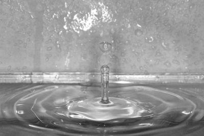 Close-up of drop falling on water