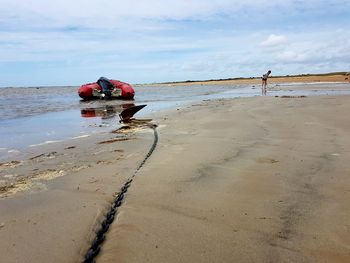 Boat on beach against sky