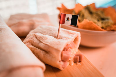 Close-up of person holding ice cream on table