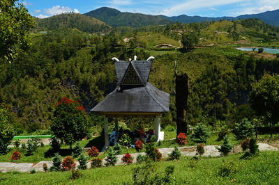 Gazebo on field against mountain range