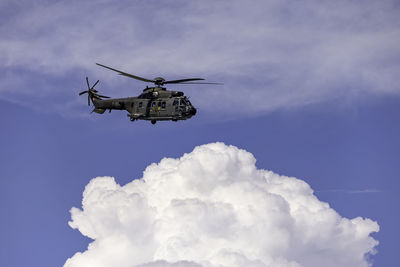 Low angle view of airplane flying against sky