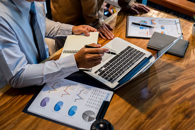 High angle view of man using laptop on table