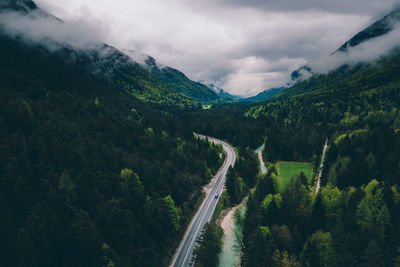 High angle view of road amidst trees against sky