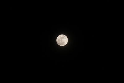 Low angle view of moon against dark sky