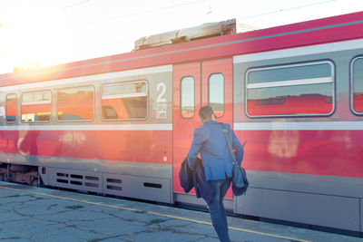 Rear view of woman on train at railroad station