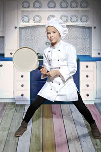 Portrait of girl standing in chef costume