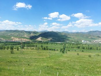 Scenic view of field against cloudy sky