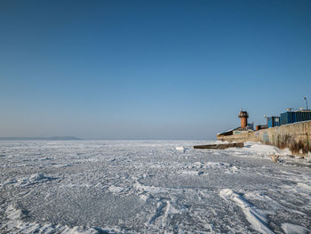 Scenic view of sea against clear sky during winter