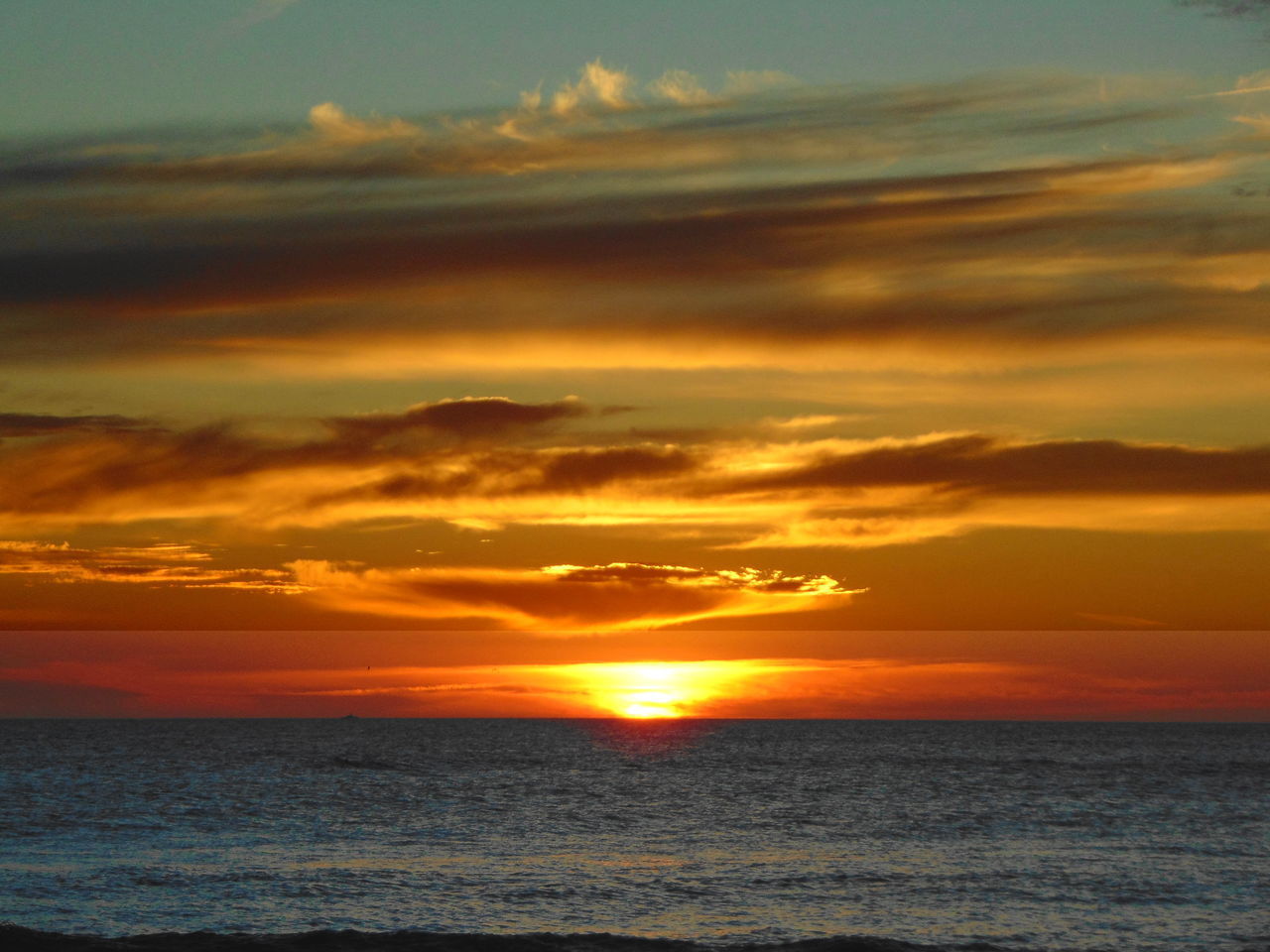 SCENIC VIEW OF SEA AT SUNSET