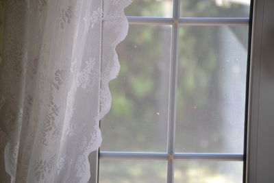 Curtain hanging by window at home