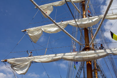 Low angle view of sailboat in sea against sky