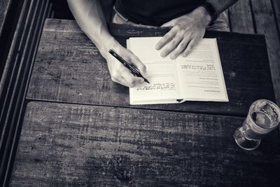 Low section of man sitting on table