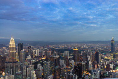 Illuminated cityscape against sky