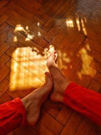 Low section of person relaxing on floor