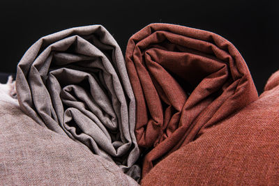 Close-up of hat on bed against black background