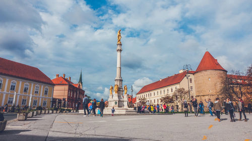 Group of people in front of buildings in city