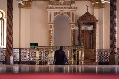 Rear view of a man walking in temple