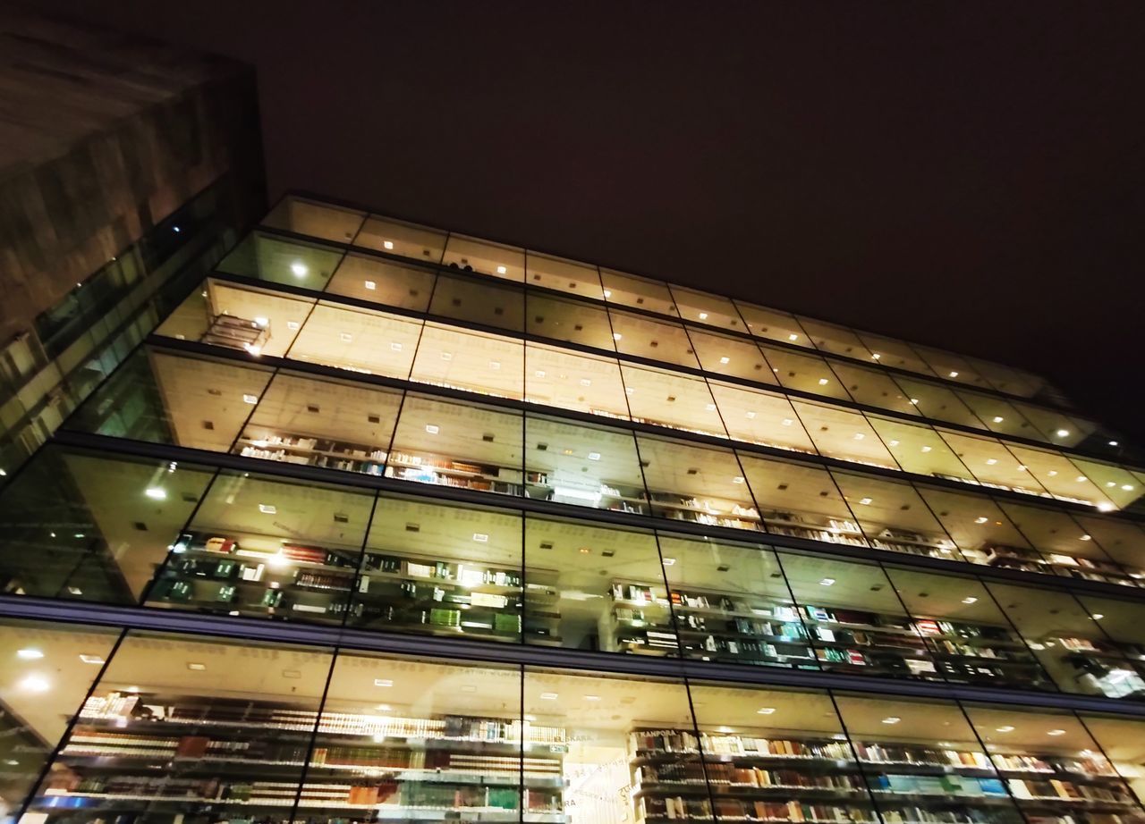 LOW ANGLE VIEW OF ILLUMINATED BUILDINGS AGAINST SKY AT NIGHT