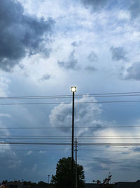 Low angle view of telephone pole against sky