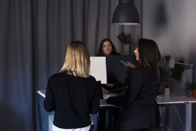 Female coworkers talking in office