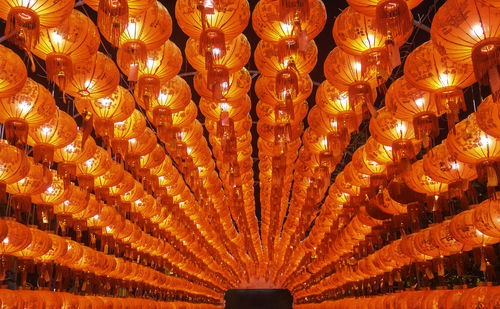 Low angle view of illuminated lanterns hanging on ceiling