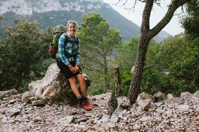 Woman sitting on rock
