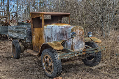 Abandoned vintage car on field