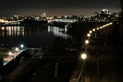 Illuminated city against sky at night